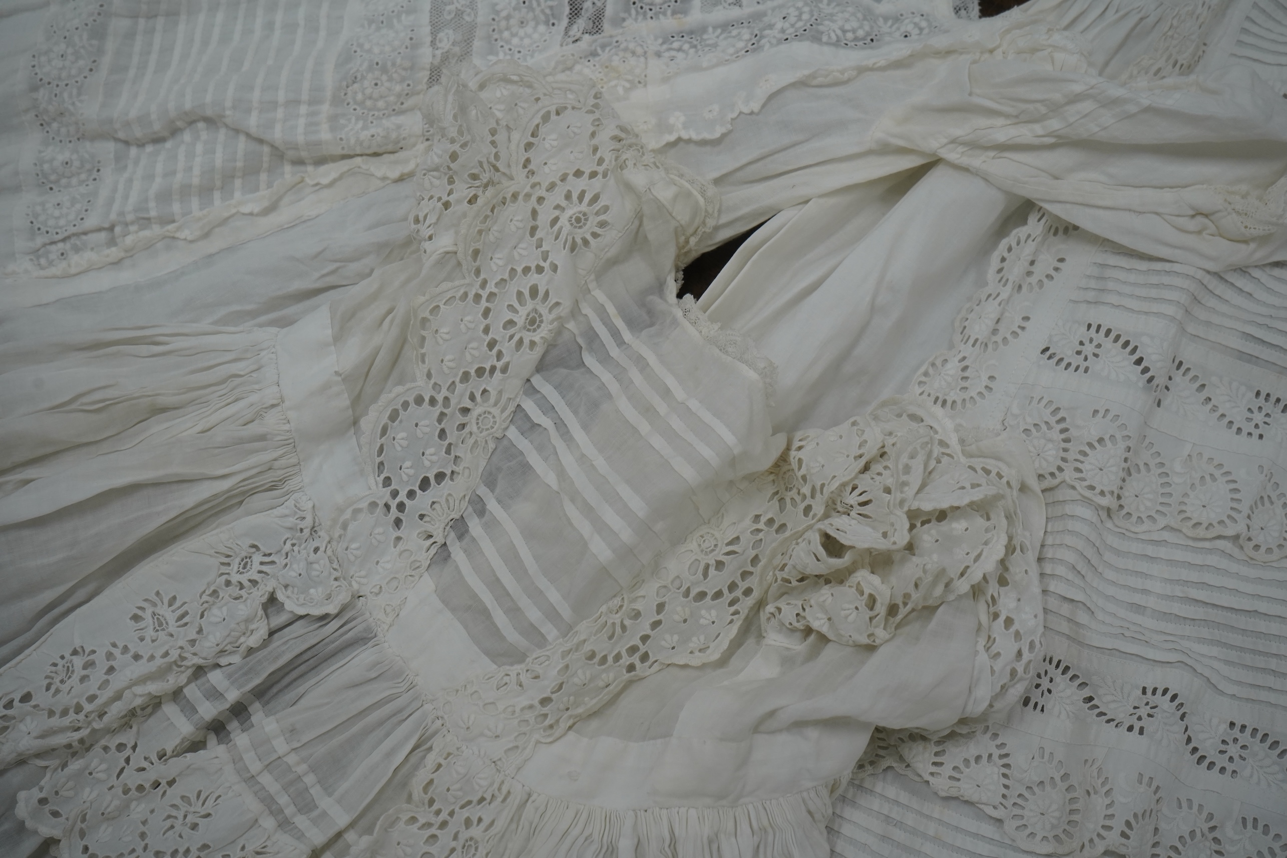 Five Victorian white worked fine cotton and lawn baby’s christening gowns. mostly worked with embroidery anglaise, feather stitching, tucking, drawn thread work and lace edging, longest 41cm. Condition - in good conditio